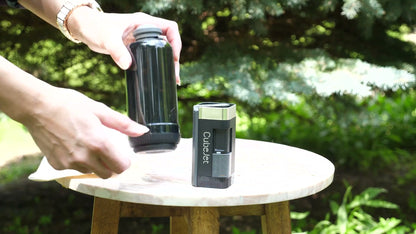 CubeJet with bottle outdoors — travel ready